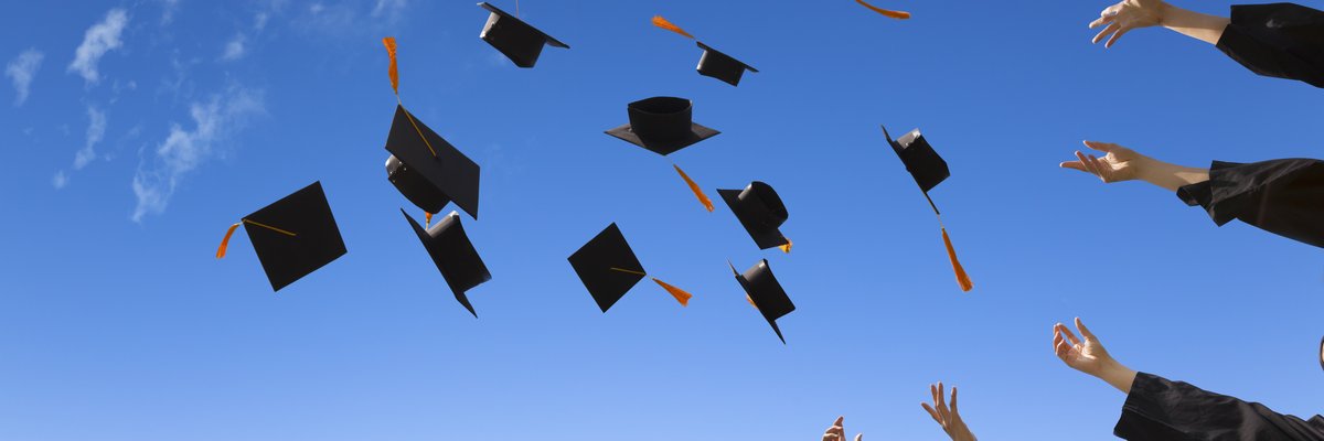 graduation hats thrown into sky