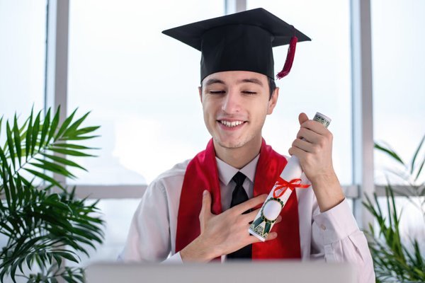 young man at online university graduation